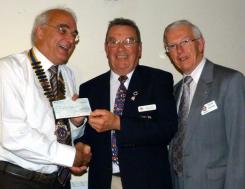 Colin Senior of RNLI receives a cheque from President William Smith. David Garforth gave the vote of thanks
