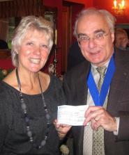 Inner Wheel President Maureen Grace accepts a cheque from Rotary