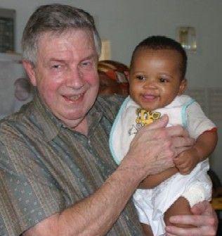Rotarian Ron Sagar with a child in Lesotho.